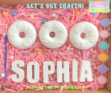 Three plaster of Paris doughnuts. Six pastel coloured paints, paintbrush. Plaster of Paris letters spelling Sophia.