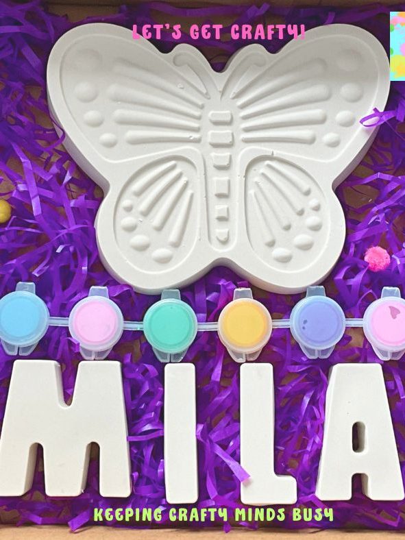 Large plaster of Paris butterfly, six paints, name spelling Mila. All o top of purple tissue paper. 